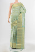 Pure Silk Pure Zari Pista Green Kanchipuram Saree with Zari Butta on the body and Silk Border.  displayed on a mannequin