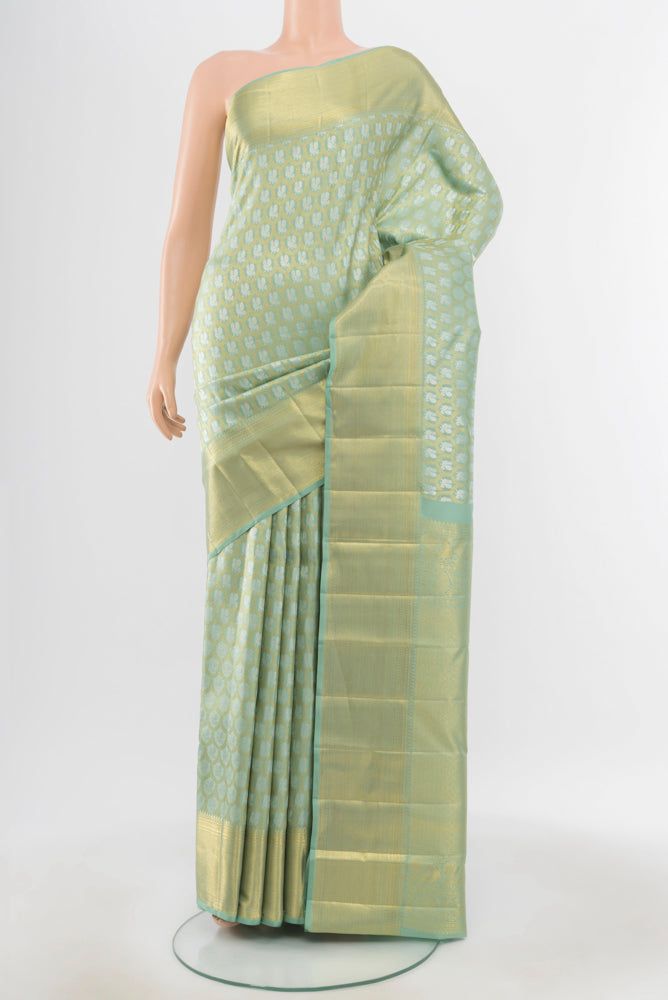 Pure Silk Pure Zari Pista Green Kanchipuram Saree with Zari Butta on the body and Silk Border.  displayed on a mannequin