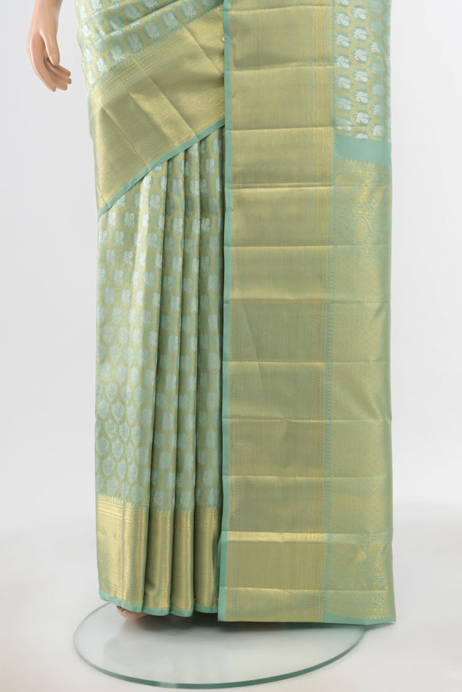 Pleats and pallu of Pure Silk Pure Zari Pista Green Kanchipuram Saree with Zari Butta on the body and Silk Border. 
