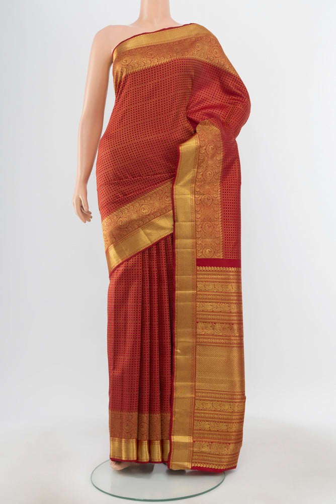 Pure Silk Pure Zari Maroon Kanjivaram Saree with Zari Butta on the body and Silk Border.  displayed on a mannequin