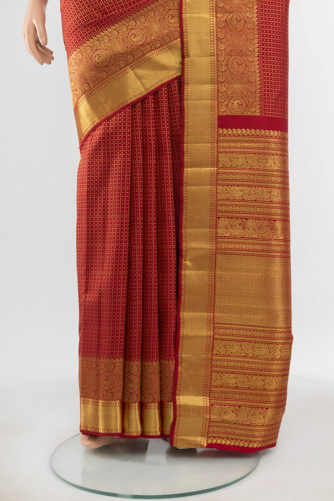 Pleats and pallu of Pure Silk Pure Zari Maroon Kanjivaram Saree with Zari Butta on the body and Silk Border. 