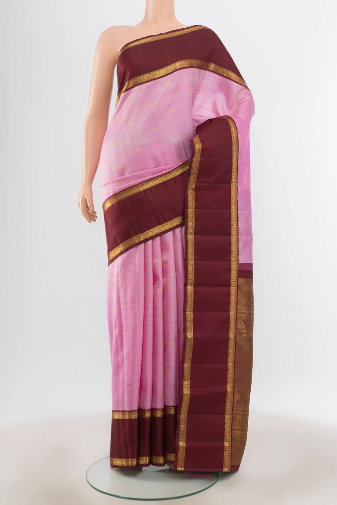 Rose Gold Kanjivaram Silk Saree with Zari Butta on the body and Silk Border.  displayed on a mannequin