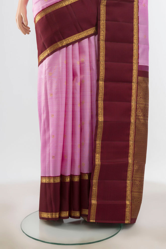 Pleats and pallu of Rose Gold Kanjivaram Silk Saree with Zari Butta on the body and Silk Border. 