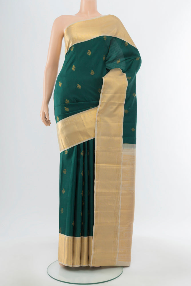 Mint Green Kanjivaram Silk Saree with Zari Butta on the body and Silk Border.  displayed on a mannequin