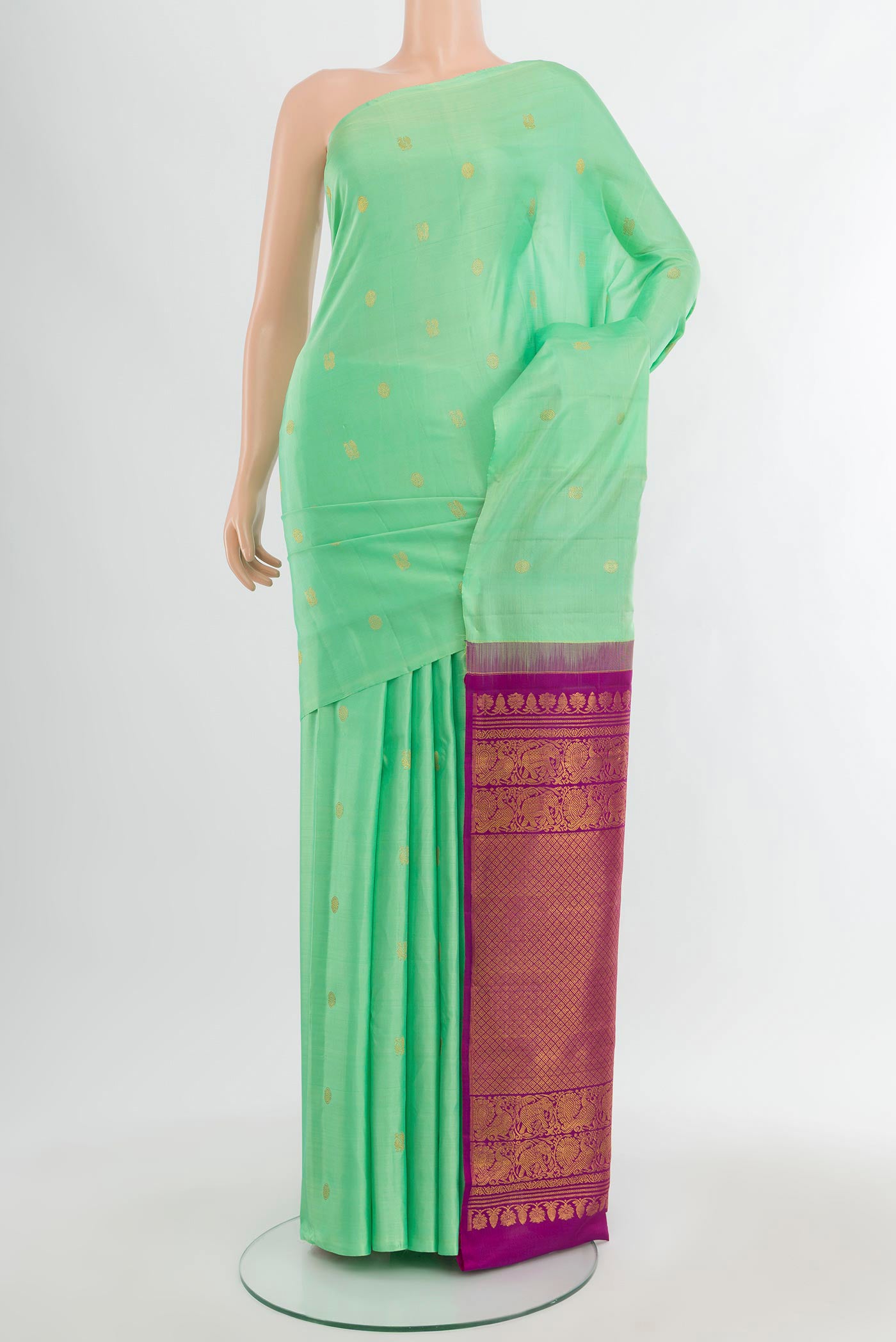 Mint Green Kanchipuram Silk Saree with Zari Butta on the body and Without Border.  displayed on a mannequin