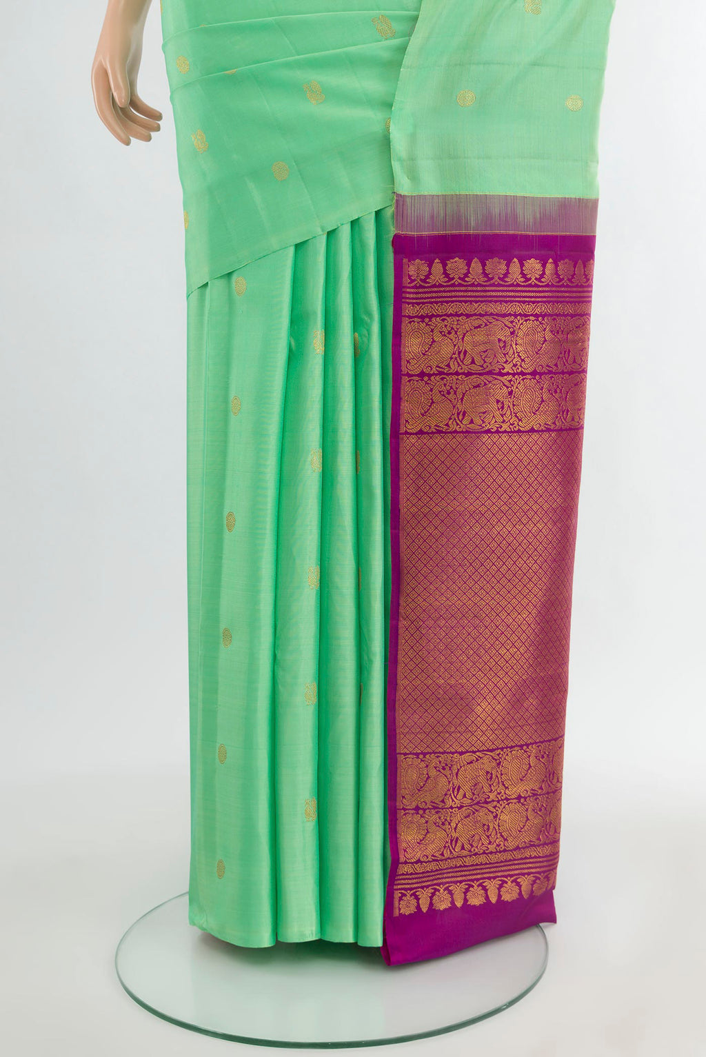 Pleats and pallu of Mint Green Kanchipuram Silk Saree with Zari Butta on the body and Without Border. 