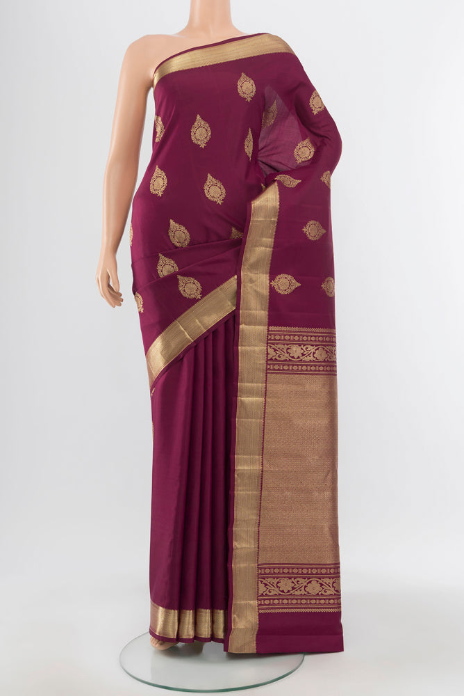 Pure Silk Pure Zari Maroon Kanjivaram Saree with Zari Butta on the body and Silk Border.  displayed on a mannequin