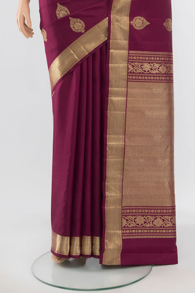 Pleats and pallu of Pure Silk Pure Zari Maroon Kanjivaram Saree with Zari Butta on the body and Silk Border. 