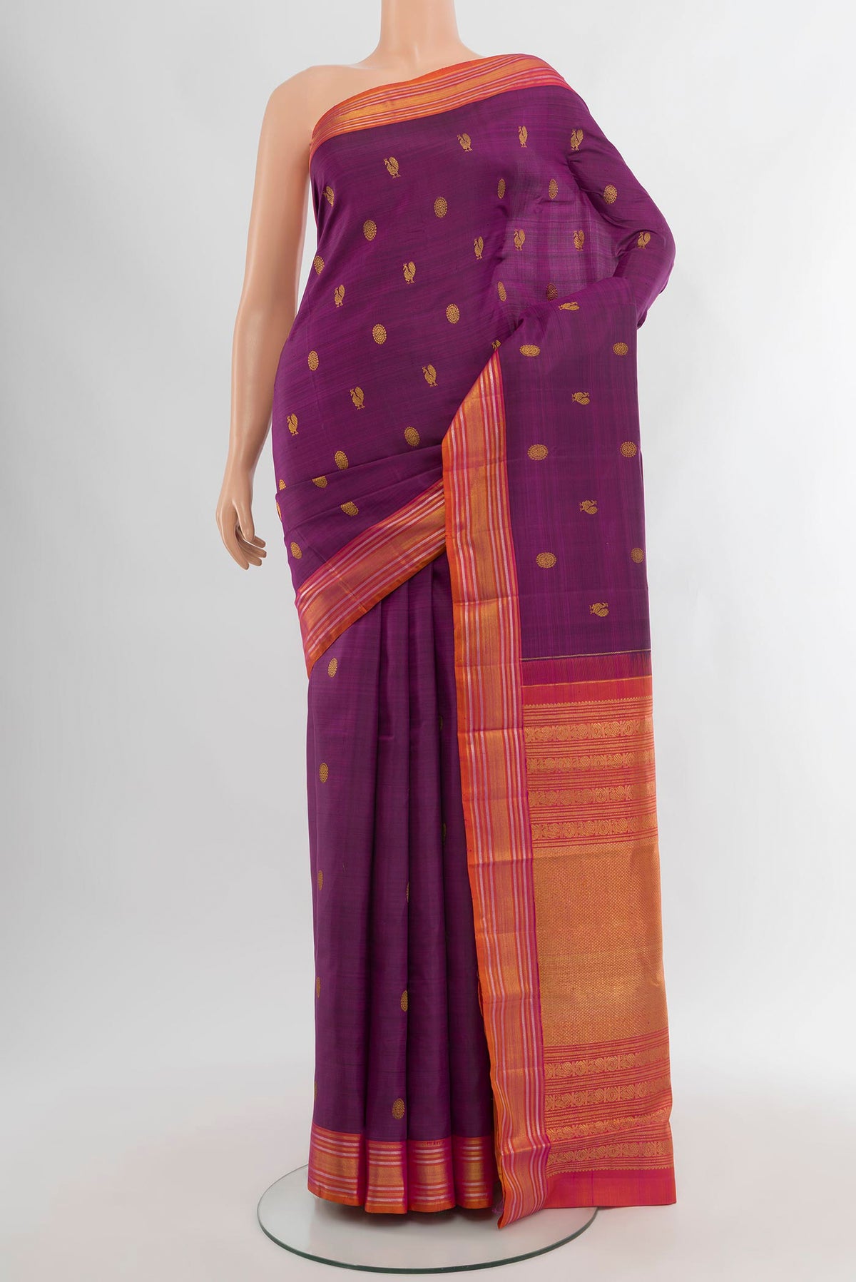Purple Kanjivaram Silk Saree with Zari Butta on the body and Zari Border.  displayed on a mannequin