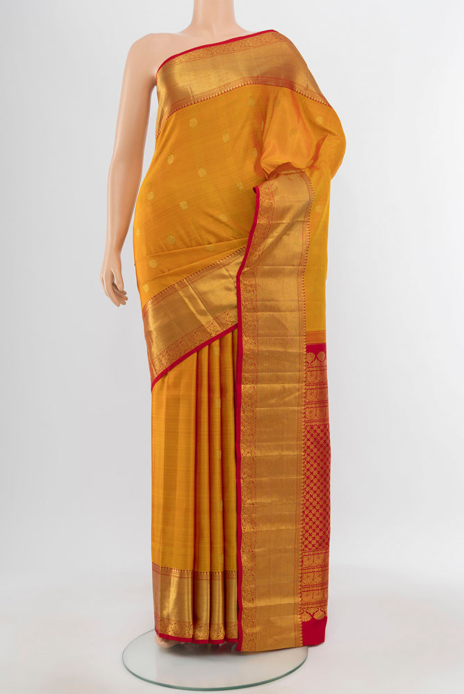 Pure Silk Pure Zari Mustard Kanjivaram Saree with Zari Butta on the body and Silk Border.  displayed on a mannequin