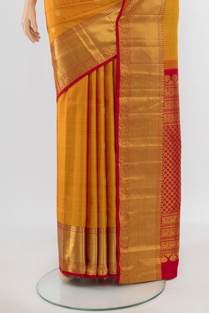 Pleats and pallu of Pure Silk Pure Zari Mustard Kanjivaram Saree with Zari Butta on the body and Silk Border. 