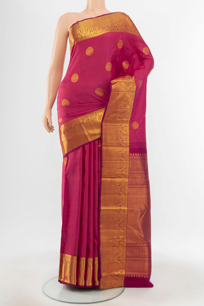 Pure Silk Pure Zari Dark Pink Kanjivaram Saree with Zari Butta on the body and Silk Border.  displayed on a mannequin