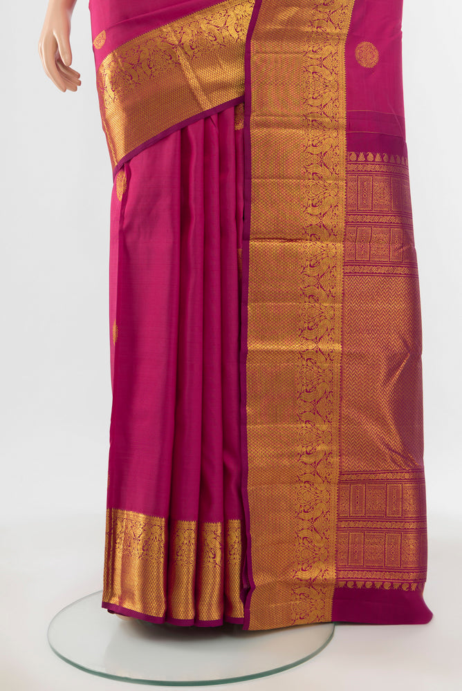 Pleats and pallu of Pure Silk Pure Zari Dark Pink Kanjivaram Saree with Zari Butta on the body and Silk Border. 