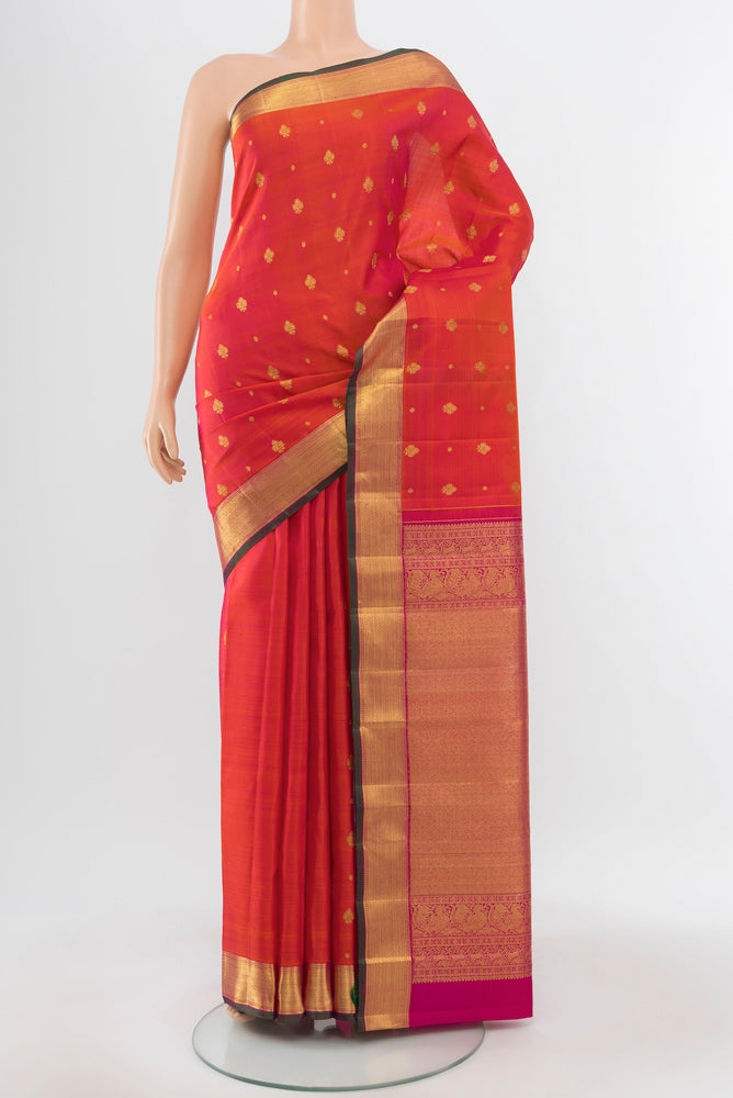 Peach Kanjivaram Silk Saree with Zari Butta on the body and Silk Border.  displayed on a mannequin
