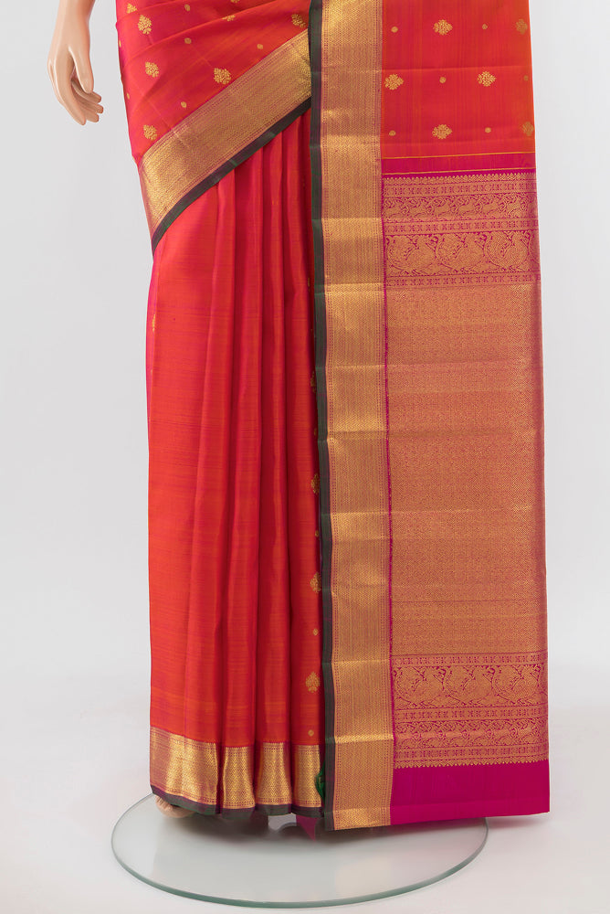 Pleats and pallu of Peach Kanjivaram Silk Saree with Zari Butta on the body and Silk Border. 