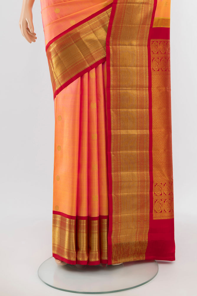 Pleats and pallu of Pure Silk Pure Zari Peach Kanchipuram Saree with Zari Butta on the body and Silk Border. 