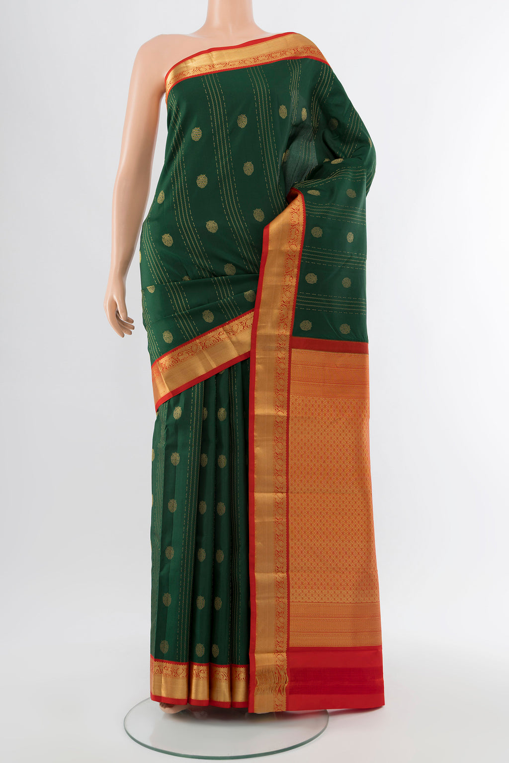 Bottle Green Kanchipuram Silk Saree with Zari Butta on the body and Silk Border.  displayed on a mannequin