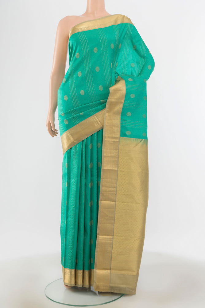 Sky Blue Kanchipuram Silk Saree with Zari Butta on the body and Silk Border.  displayed on a mannequin