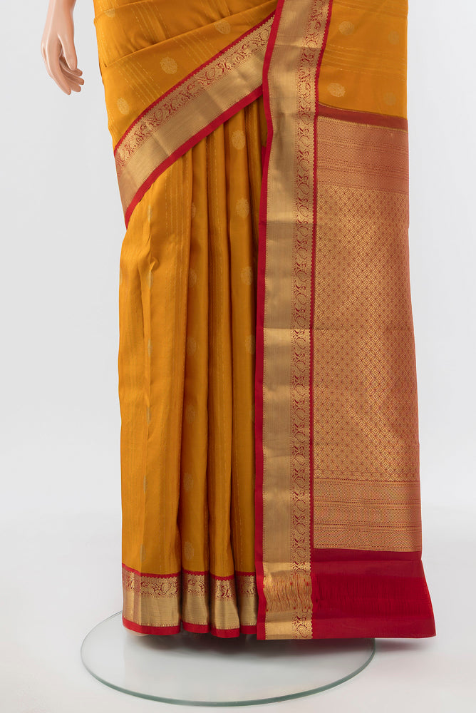 Pleats and pallu of Pure Silk Pure Zari Mustard Kanchipuram Saree with Zari Brocade on the body and Silk Border. 