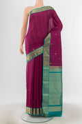 Purple Kanchipuram Silk Saree with Zari Butta on the body and Silk Border.  displayed on a mannequin