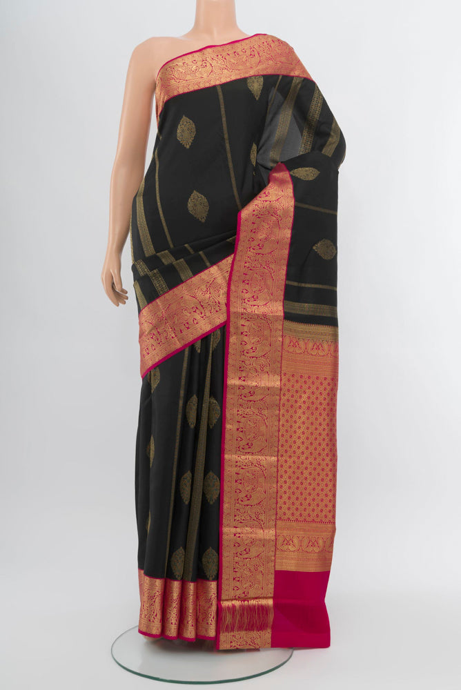 Black Kanchipuram Silk Saree with Zari Butta on the body and Silk Border.  displayed on a mannequin