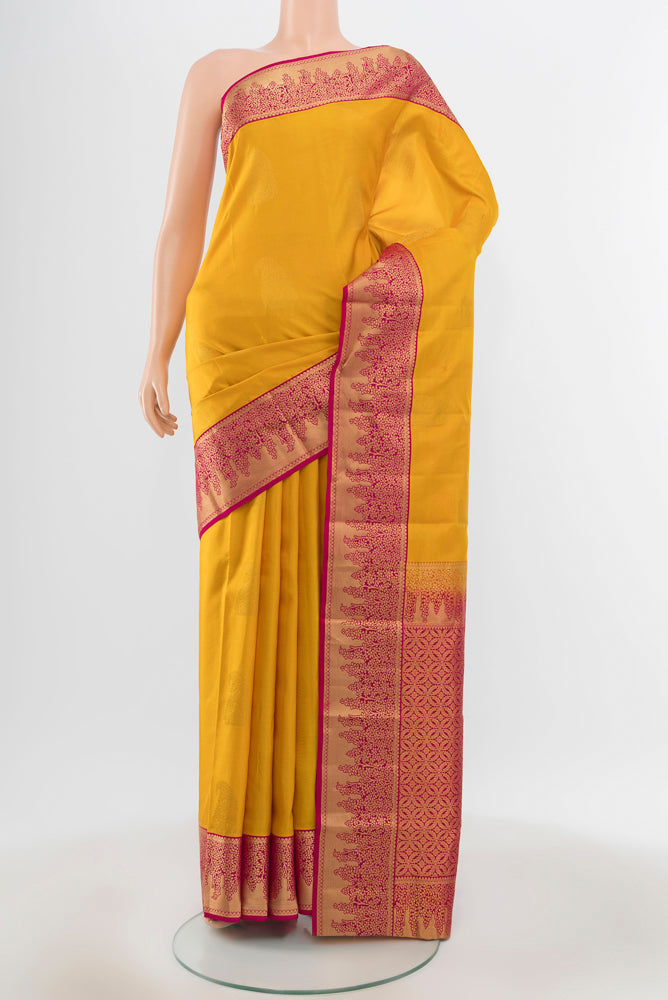 Pure Silk Pure Zari Yellow Kanchipuram Saree with Zari Butta on the body and Silk Border.  displayed on a mannequin