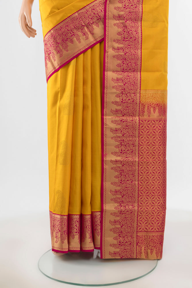 Pleats and pallu of Pure Silk Pure Zari Yellow Kanchipuram Saree with Zari Butta on the body and Silk Border. 