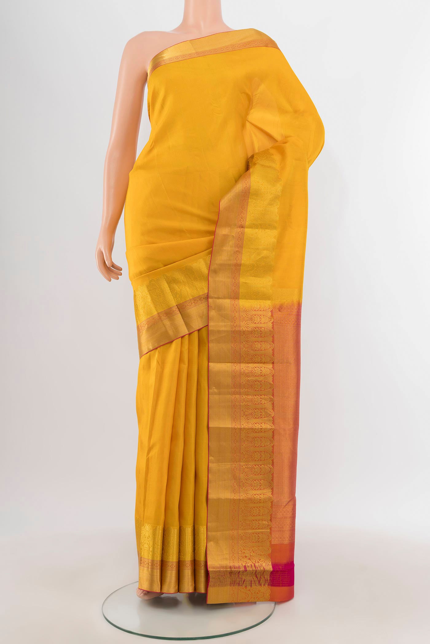 Yellow Kanchipuram Silk Saree with Zari Butta on the body and Zari Border.  displayed on a mannequin