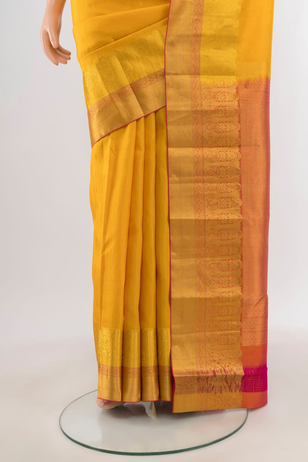 Pleats and pallu of Yellow Kanchipuram Silk Saree with Zari Butta on the body and Zari Border. 