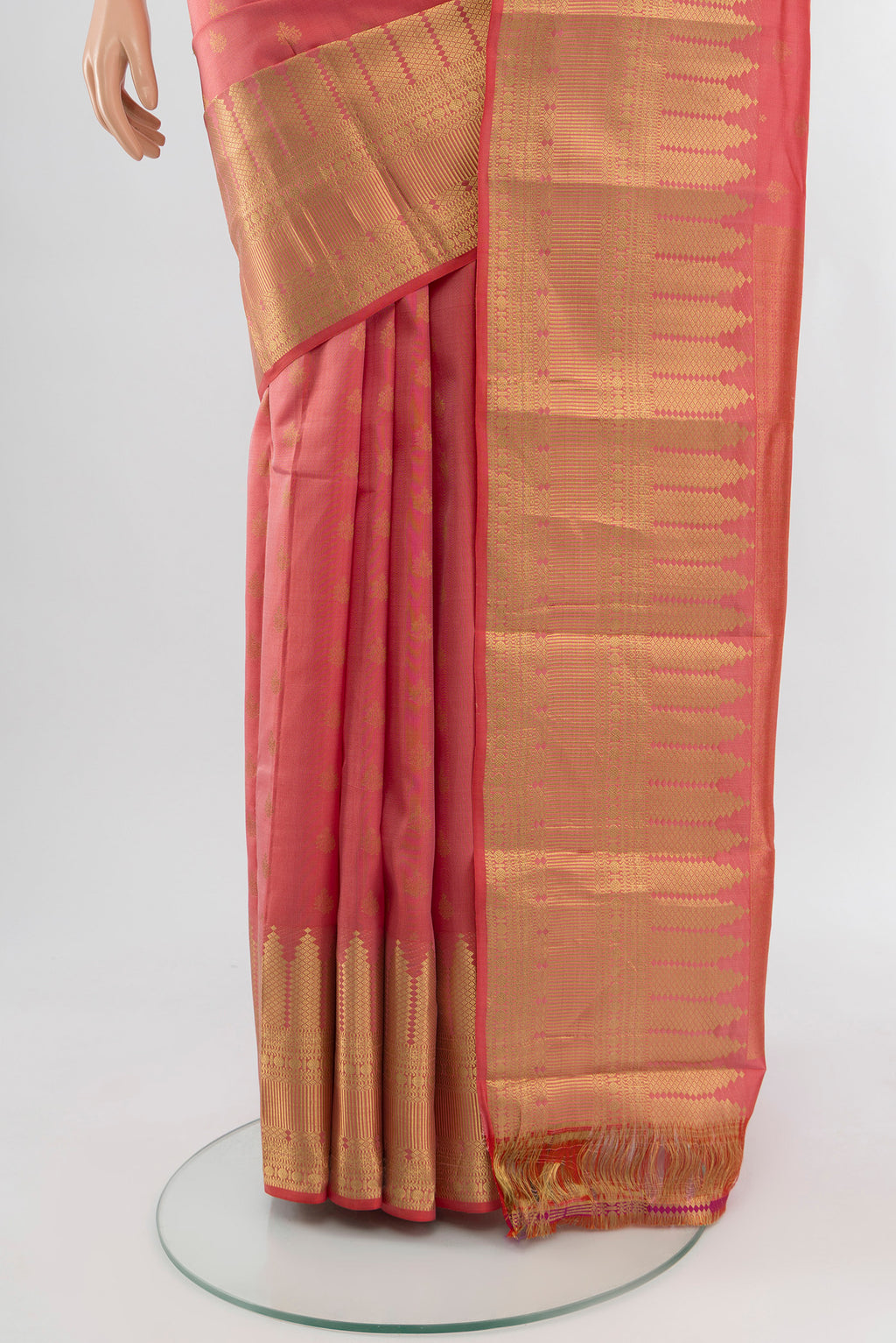 Pleats and pallu of Coral Kanchipuram Silk Saree with Zari Butta on the body and Zari Border. 