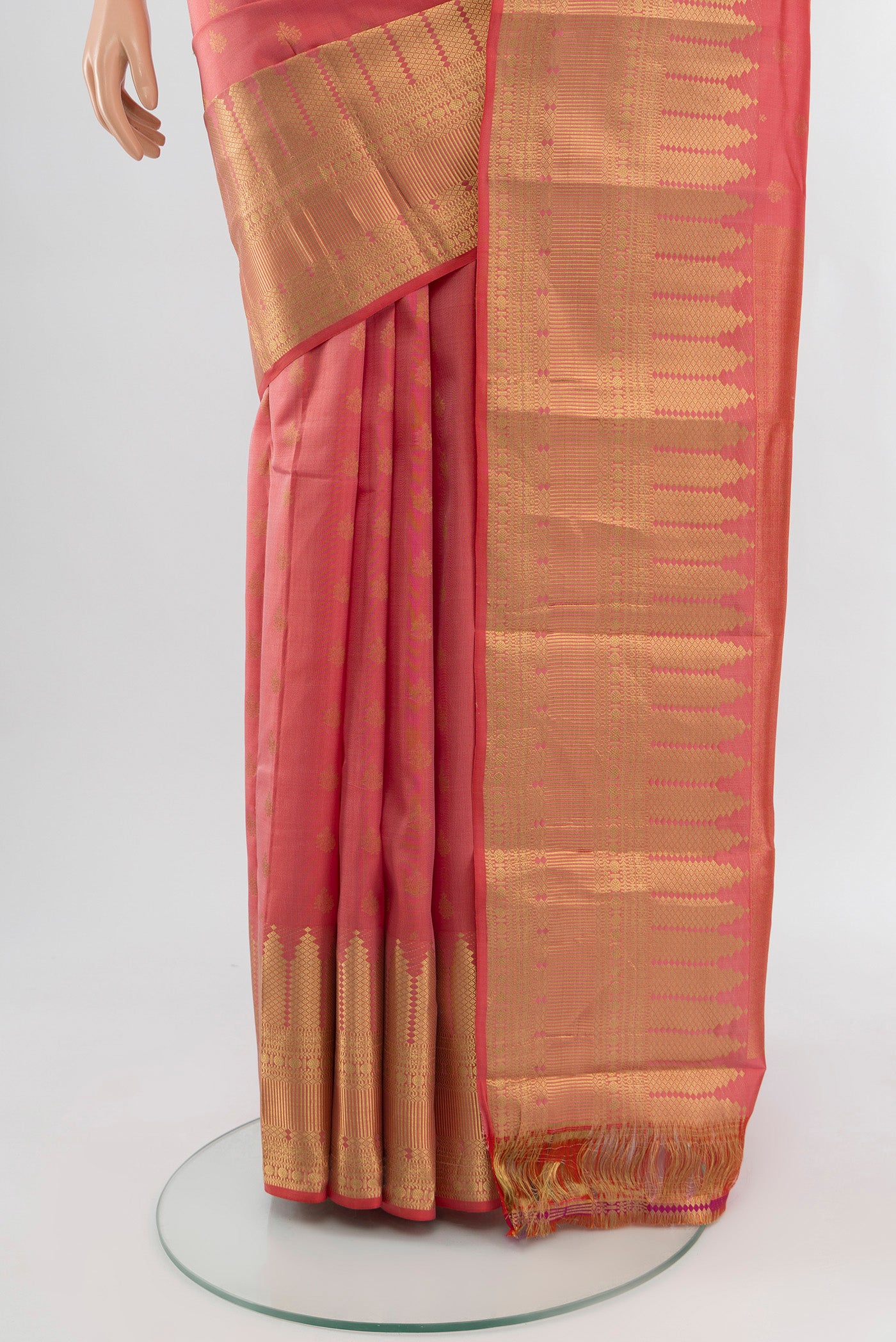 Pleats and pallu of Coral Kanchipuram Silk Saree with Zari Butta on the body and Zari Border. 