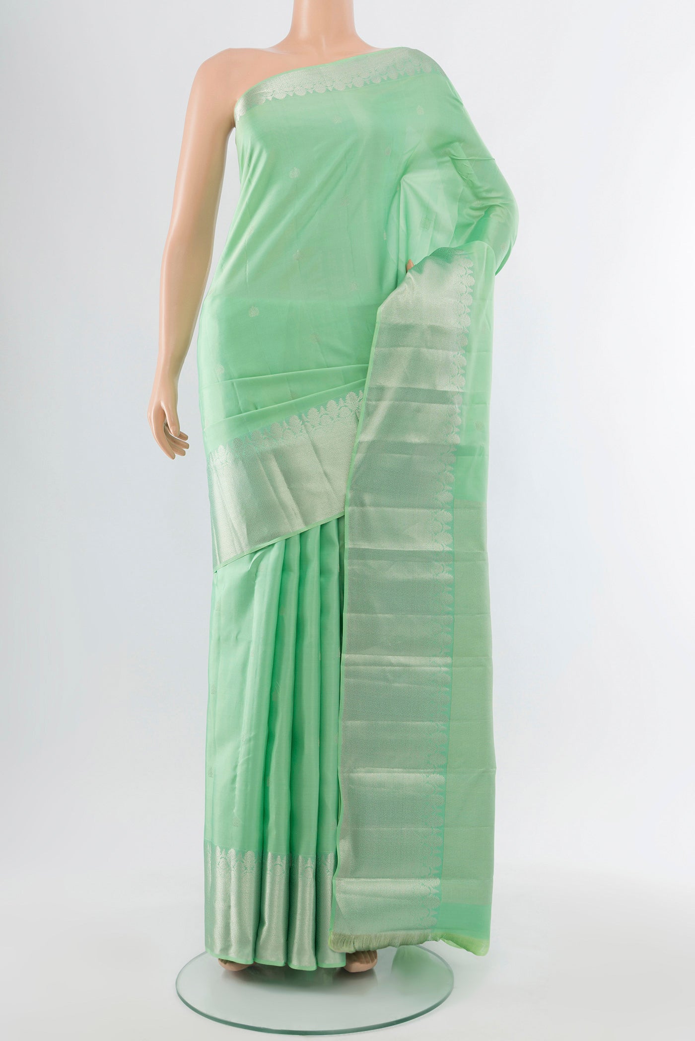 Sea Green Kanchipuram Silk Saree with Zari Butta on the body and Silk Border.  displayed on a mannequin
