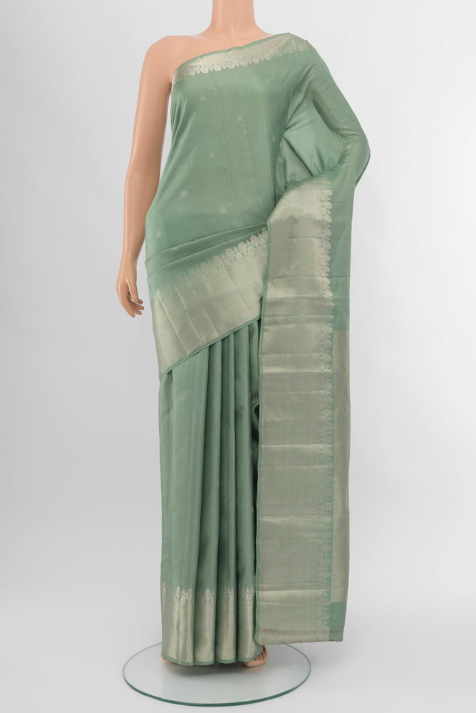 Olive Green Kanchipuram Silk Saree with Zari Brocade on the body and Silk Border.  displayed on a mannequin