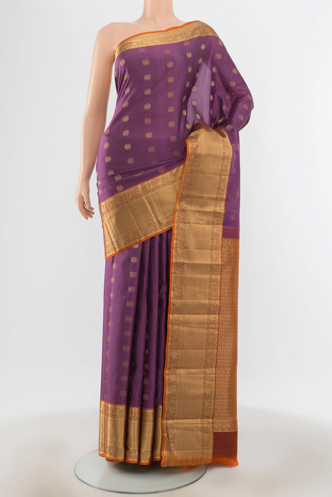 Bronze Kanchipuram Silk Saree with Zari Butta on the body and Silk Border.  displayed on a mannequin