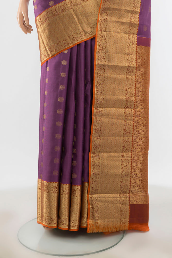 Pleats and pallu of Bronze Kanchipuram Silk Saree with Zari Butta on the body and Silk Border. 
