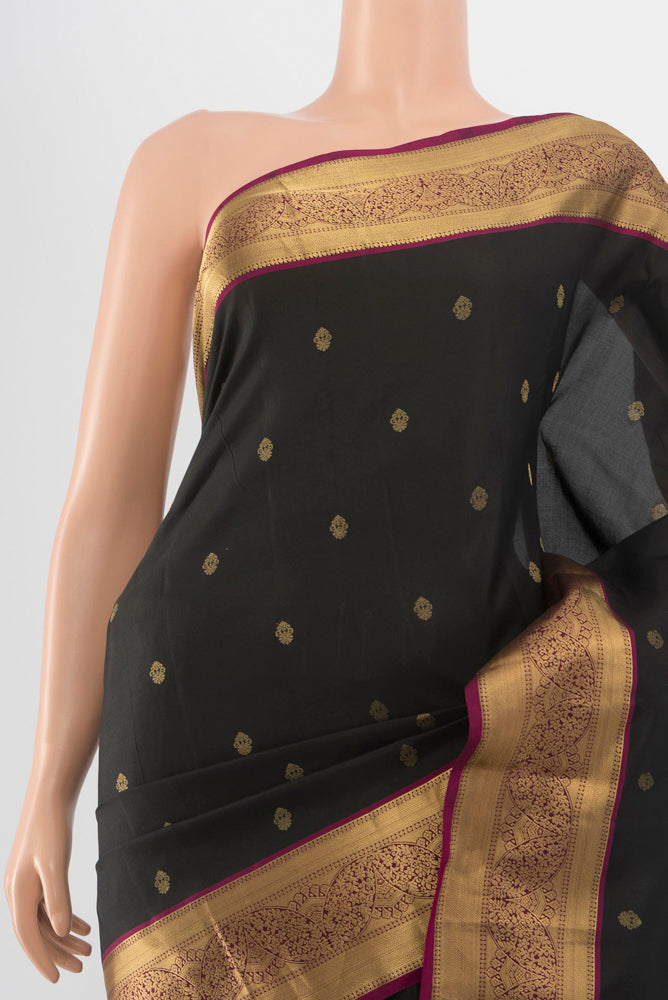 Border image of Black Kanchipuram Silk Saree with Zari Butta on the body and Silk Border. 