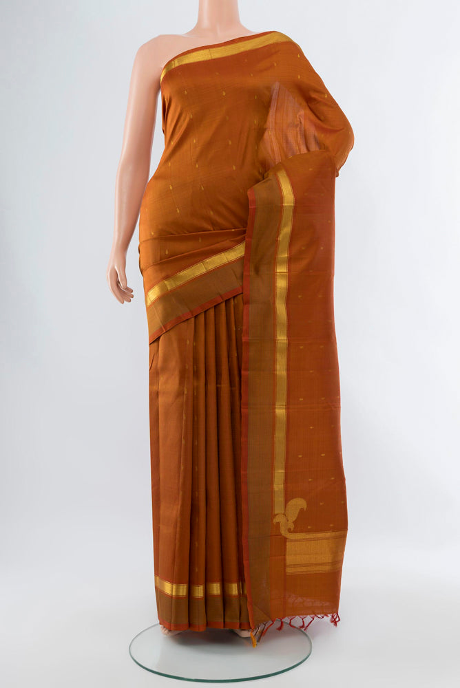 Brown Kanchipuram Silk Saree with Zari Butta on the body and Silk Border.  displayed on a mannequin