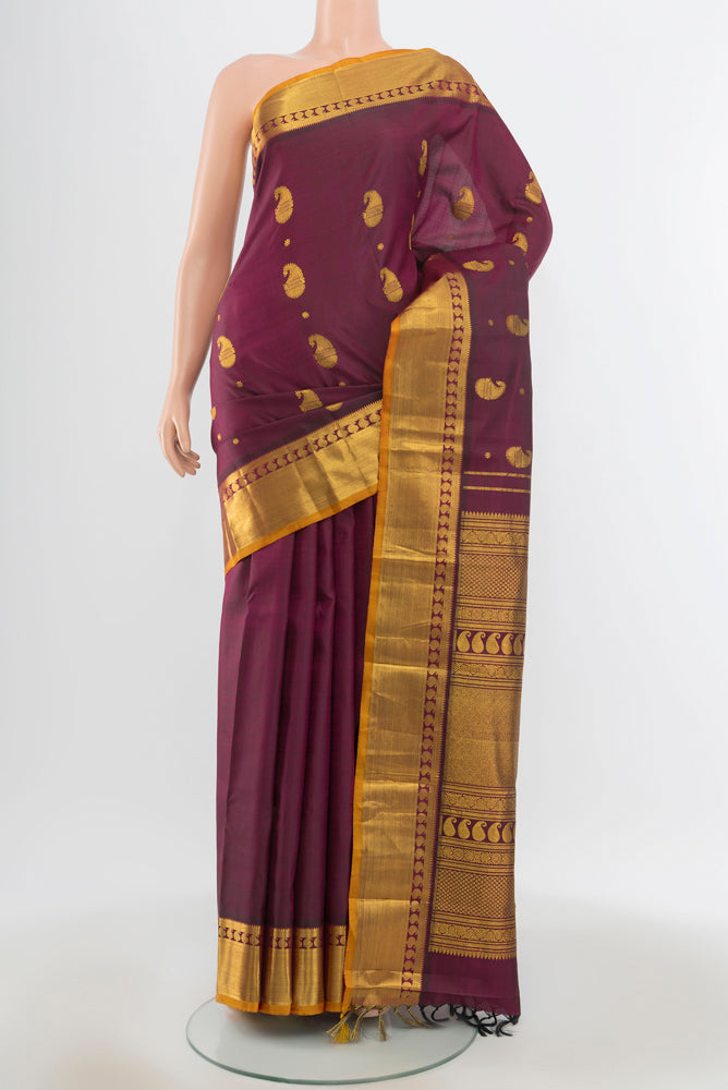 Pure Silk Pure Zari Maroon Kanjivaram Saree with Zari Butta on the body and Silk Border.  displayed on a mannequin