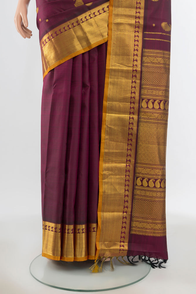 Pleats and pallu of Pure Silk Pure Zari Maroon Kanjivaram Saree with Zari Butta on the body and Silk Border. 