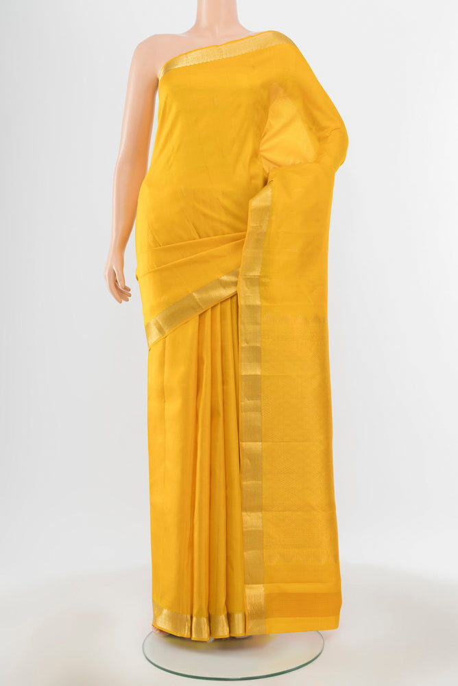 Pure Silk Pure Zari Yellow Kanjivaram Saree with Zari Butta on the body and Silk Border.  displayed on a mannequin