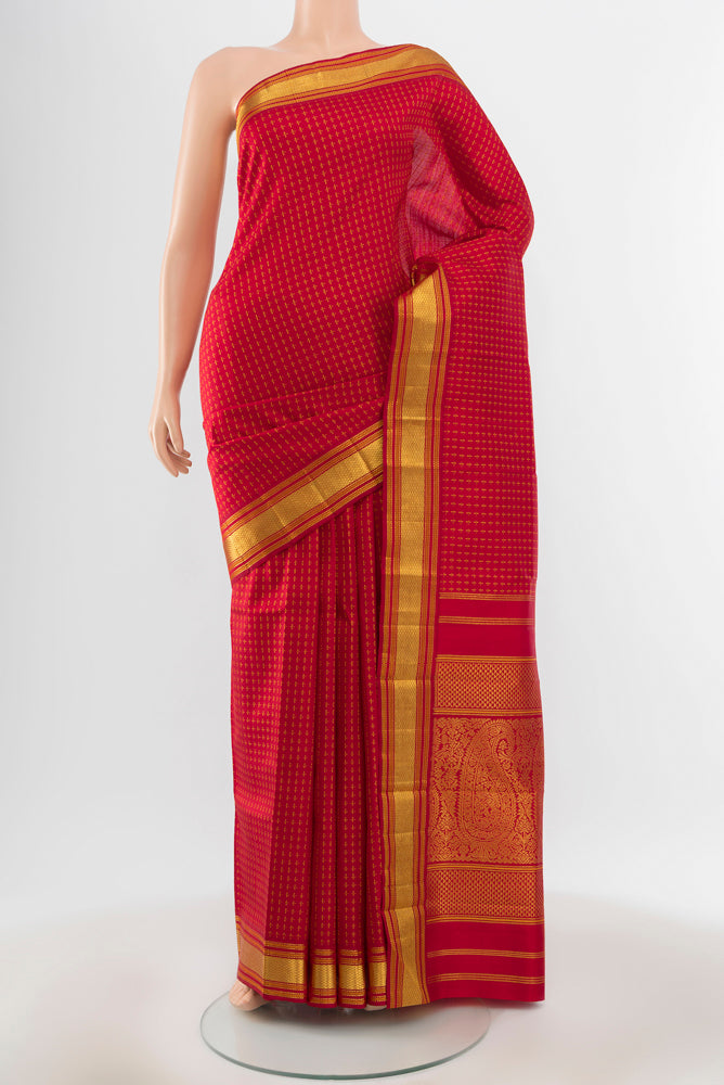 Pure Silk Pure Zari Maroon Kanjivaram Saree with Zari Butta on the body and Silk Border.  displayed on a mannequin