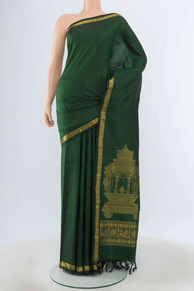 Pure Silk Pure Zari Bottle Green Kanjivaram Saree with Zari Butta on the body and Silk Border.  displayed on a mannequin