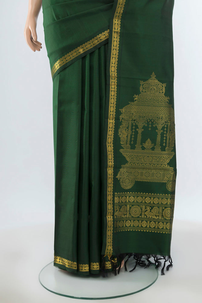 Pleats and pallu of Pure Silk Pure Zari Bottle Green Kanjivaram Saree with Zari Butta on the body and Silk Border. 