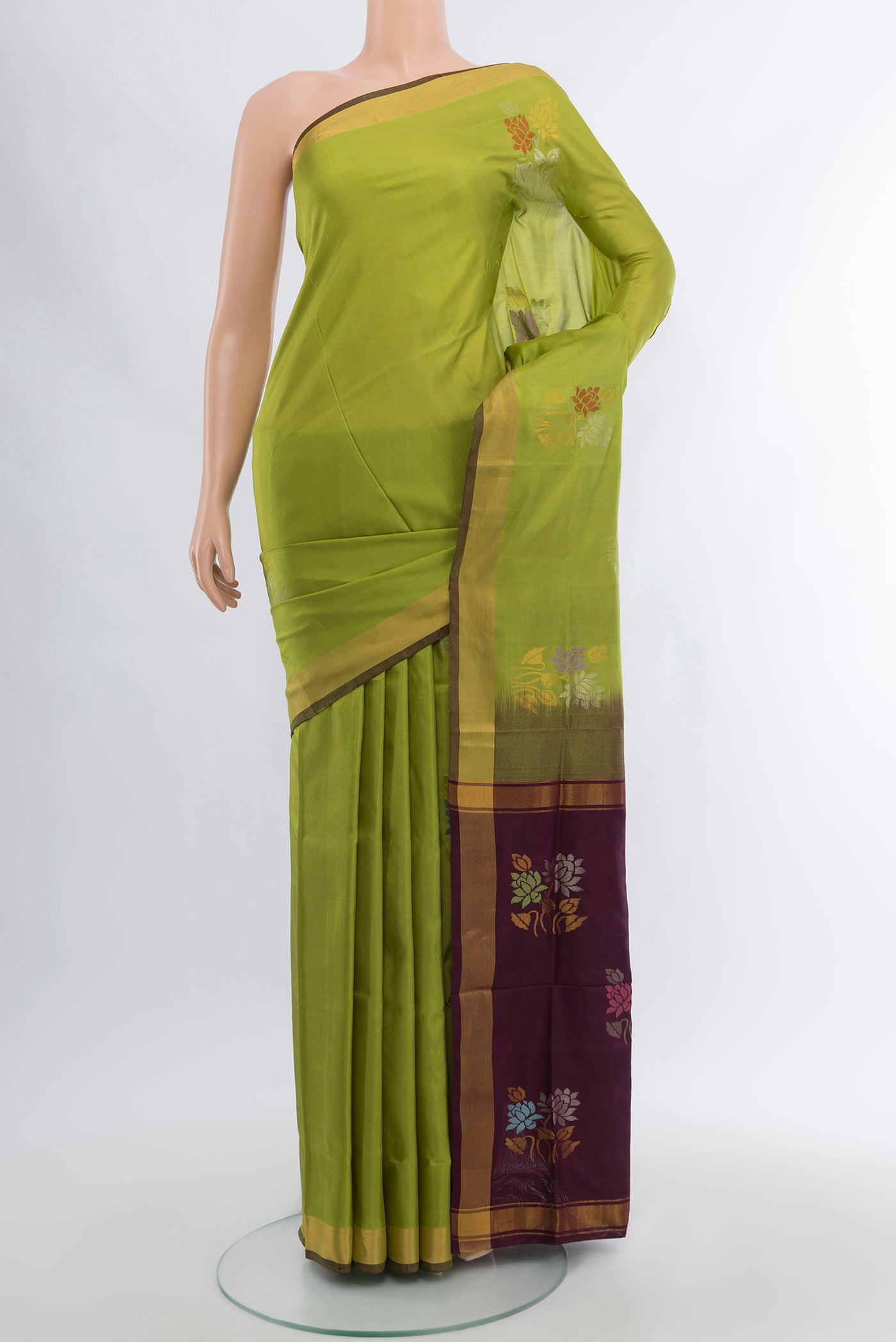 Light Green Uppada Silk Saree with Zari Butta on the body and Silk Border.  displayed on a mannequin