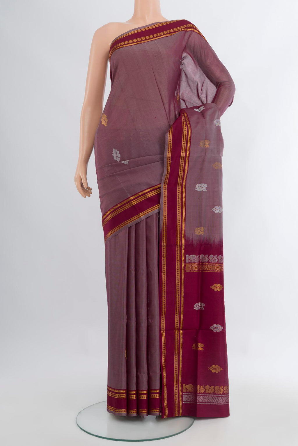 Mauve Uppada Silk Saree with Zari Butta on the body and Zari Border.  displayed on a mannequin