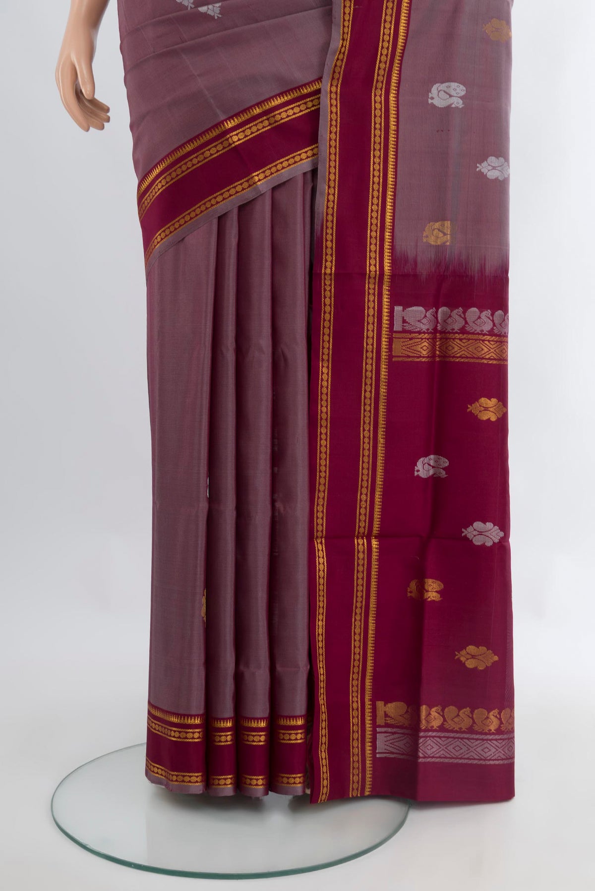 Pleats and pallu of Mauve Uppada Silk Saree with Zari Butta on the body and Zari Border. 