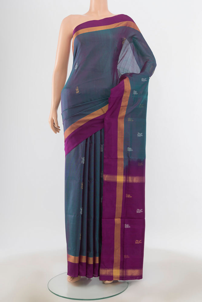 Peacock Blue Uppada Silk Saree with Zari Butta on the body and Silk Border.  displayed on a mannequin
