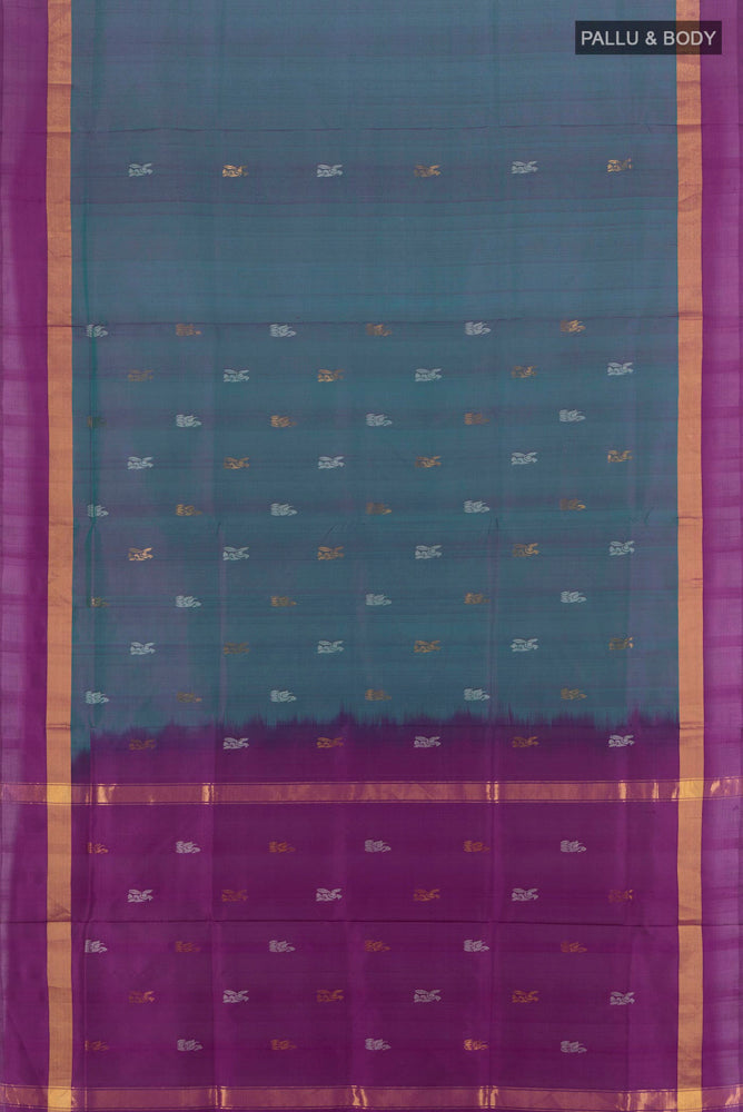 Flat view of Peacock Blue Uppada Silk Saree with Zari Butta on the body and Silk Border. 