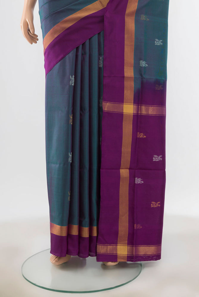 Pleats and pallu of Peacock Blue Uppada Silk Saree with Zari Butta on the body and Silk Border. 