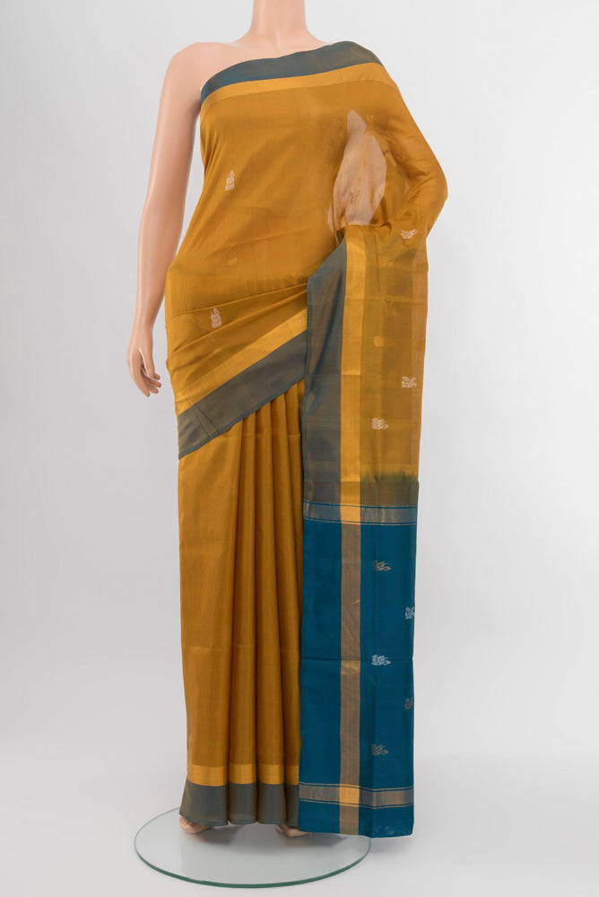 Golden Uppada Silk Saree with Zari Butta on the body and Silk Border.  displayed on a mannequin